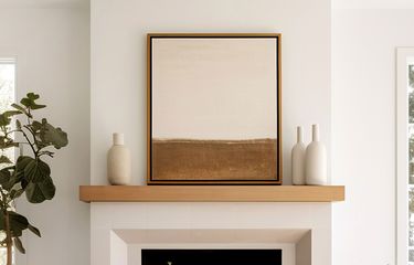 Framed canvas artwork with floating canvas frame displayed over a fireplace in a brightly lit living area
