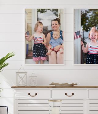 patriotic family photos in white frames in entryway 