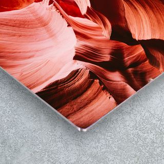 A canvas print hung behind in a foyer, behind a couch.