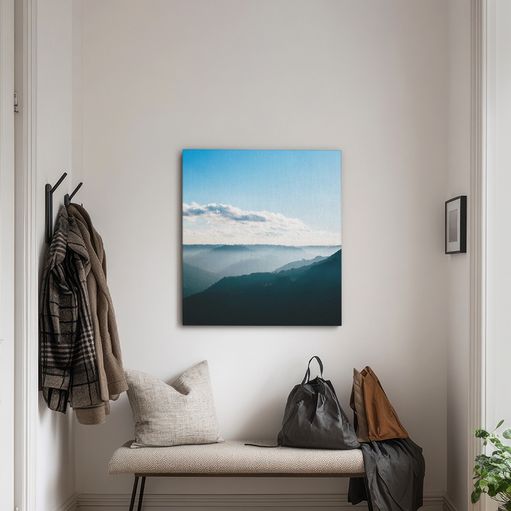 Canvas print of a landscape hanging over a bench in an entryway