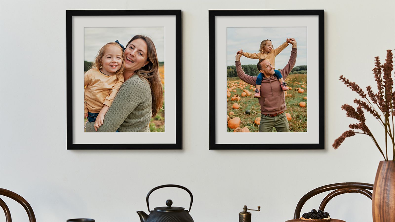 2 framed photos or parents and child with white mats in black frames with fall decor