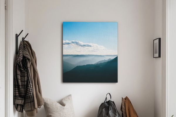Canvas print of a landscape hanging over a bench in an entryway