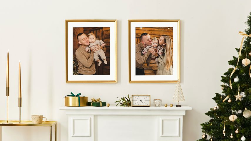 Framed prints above mantel with white mats next to decorated Christmas tree