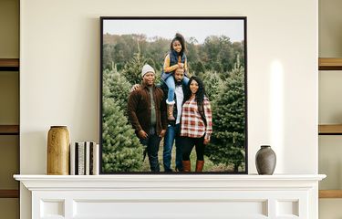Framed canvas artwork with floating canvas frame displayed over a fireplace in a brightly lit living area
