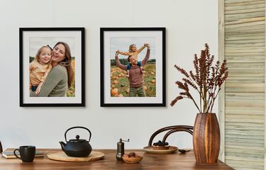 2 framed photos or parents and child with white mats in black frames with fall decor