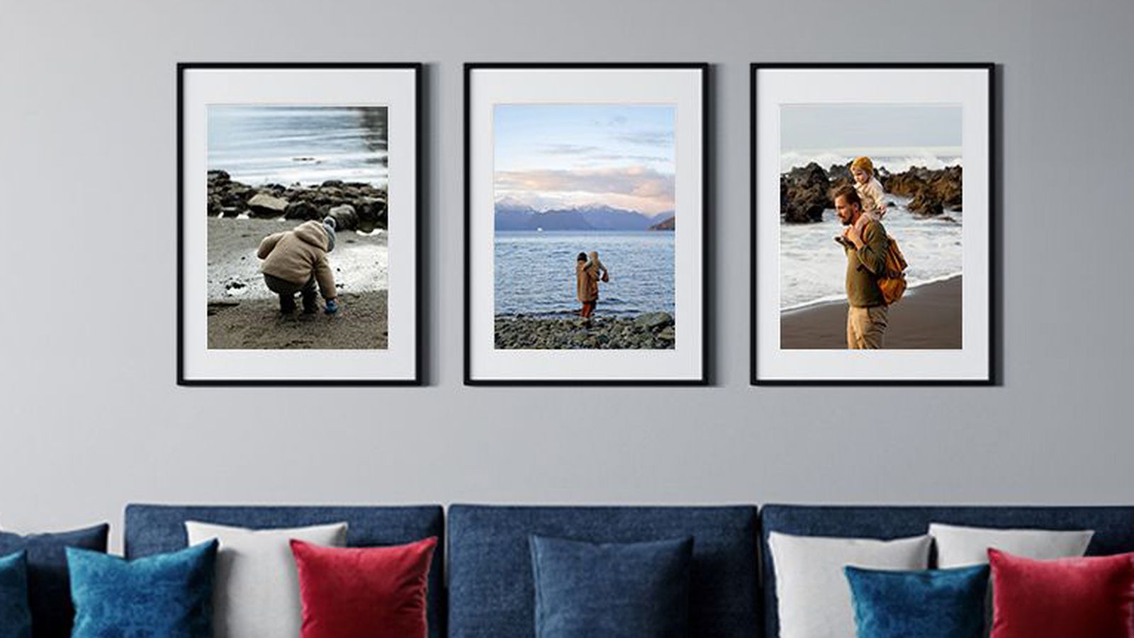 Trio of 2 framed photos of a family by the water in black frames with white mats