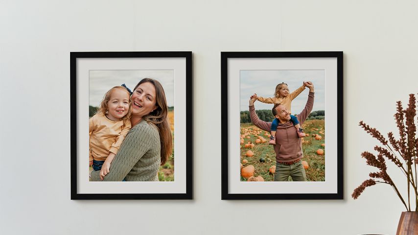 2 framed photos or parents and child with white mats in black frames with fall decor