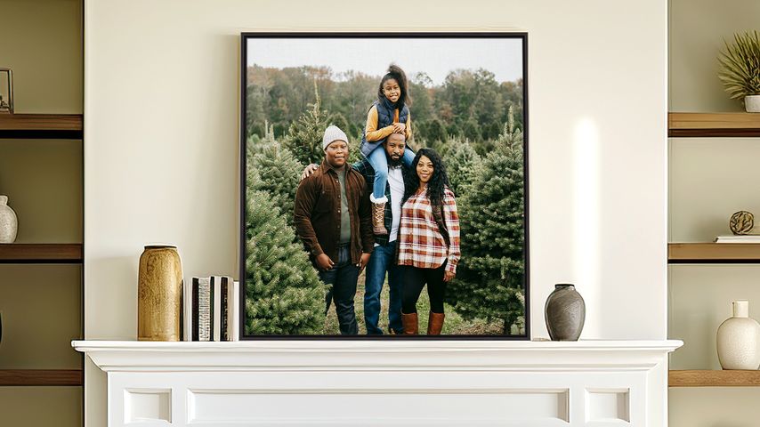 Framed canvas artwork with floating canvas frame displayed over a fireplace in a brightly lit living area