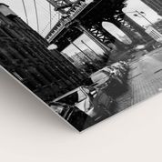 Black and white metal print showing urban architecture and buildings.